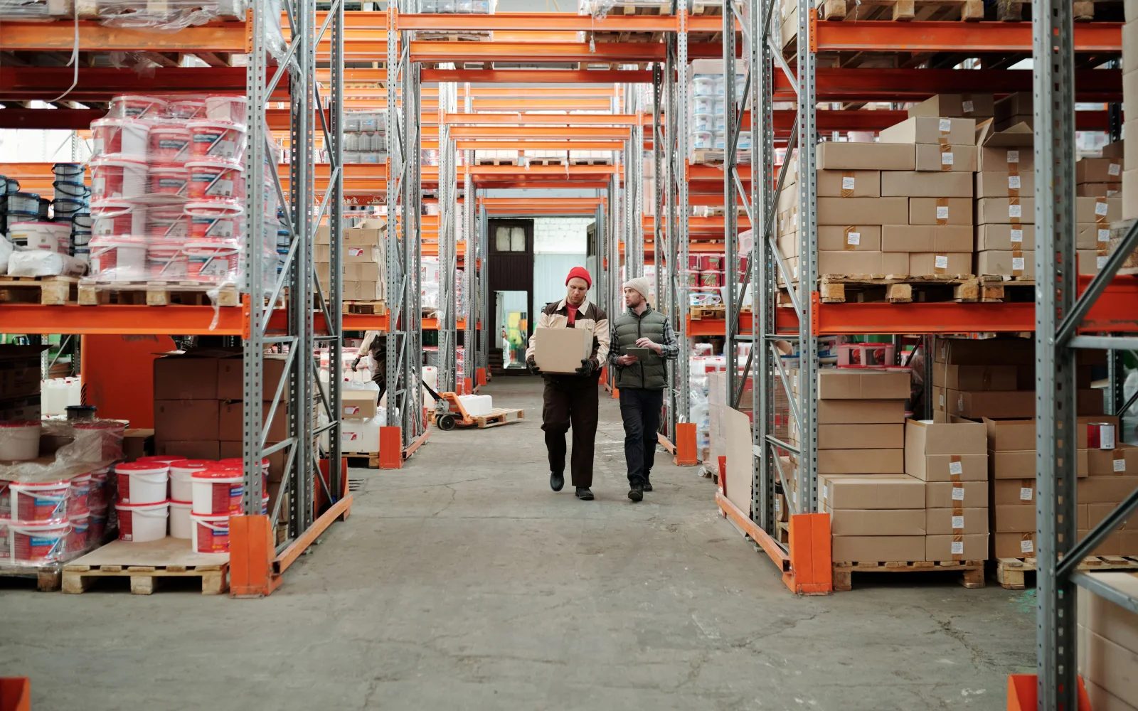 A warehouse team reviewing inventory for distribution